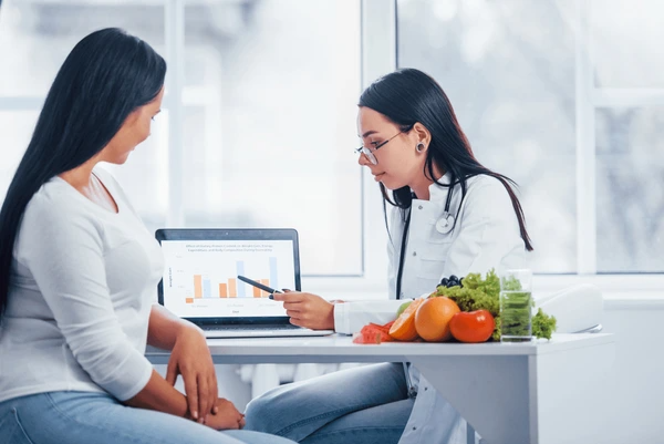 Nutritionist consulting with patient on zinc timing and interactions for optimal absorption